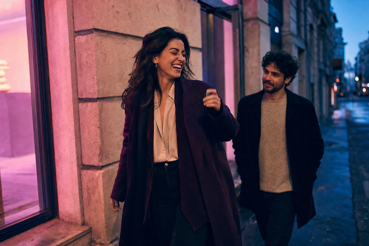 Mixed neon and natural-light street portrait of a couple in magenta, cyan, and cream