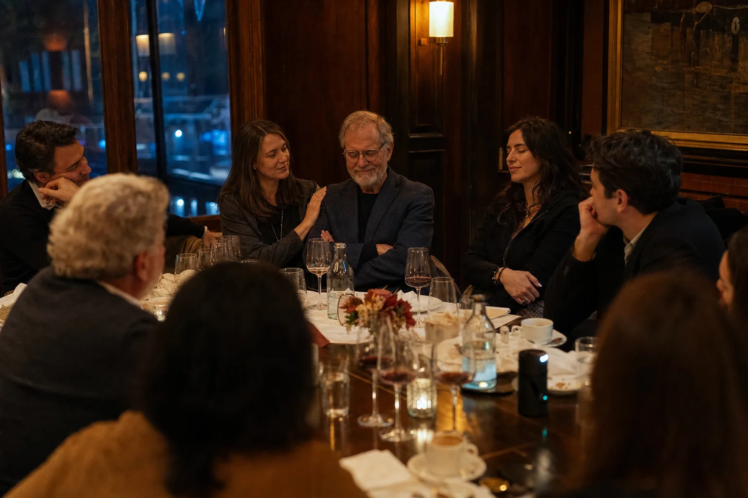 Documentary farewell dinner with colleagues listening around a long table