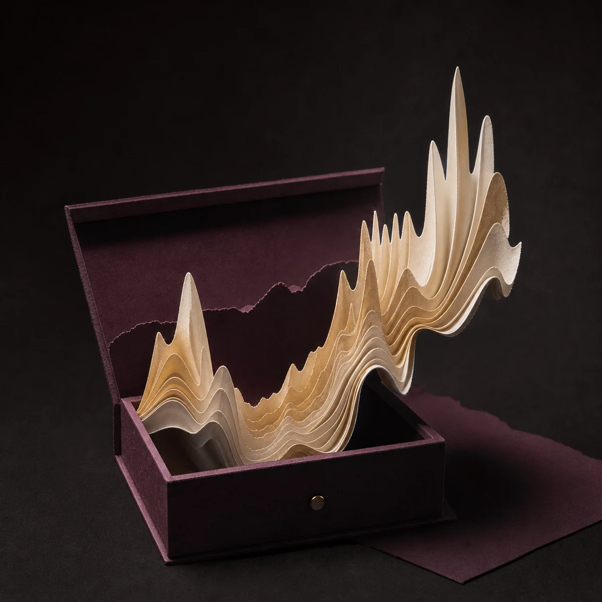 Sculptural paper waveform nested inside a keepsake gift box