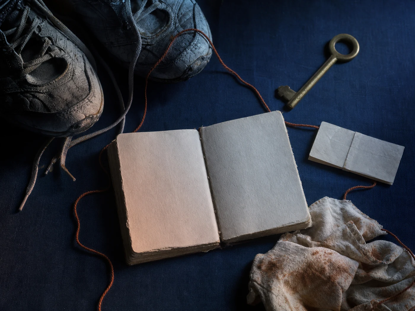 Still life of a journal, worn shoes, keys, notes, and personal chapter objects