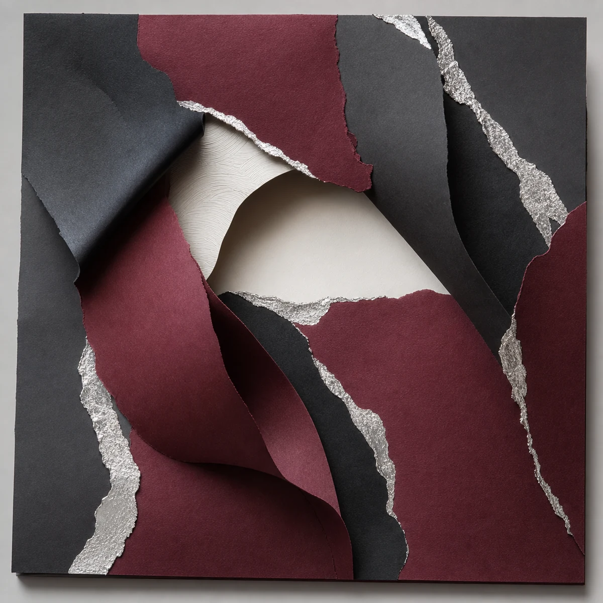 Silver foil and deep burgundy paper sculpture without text