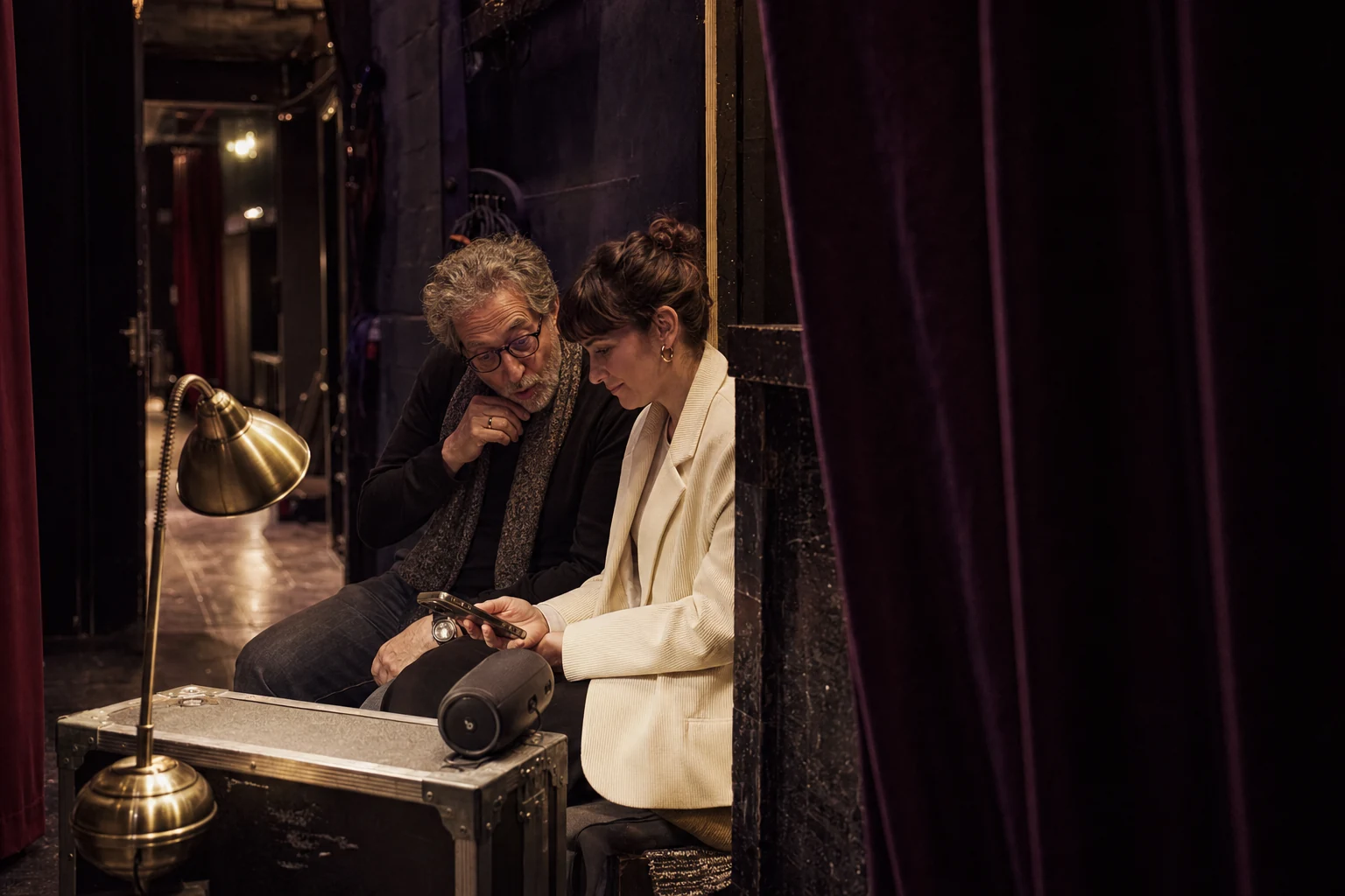 Private backstage listening moment between a mentor and mentee